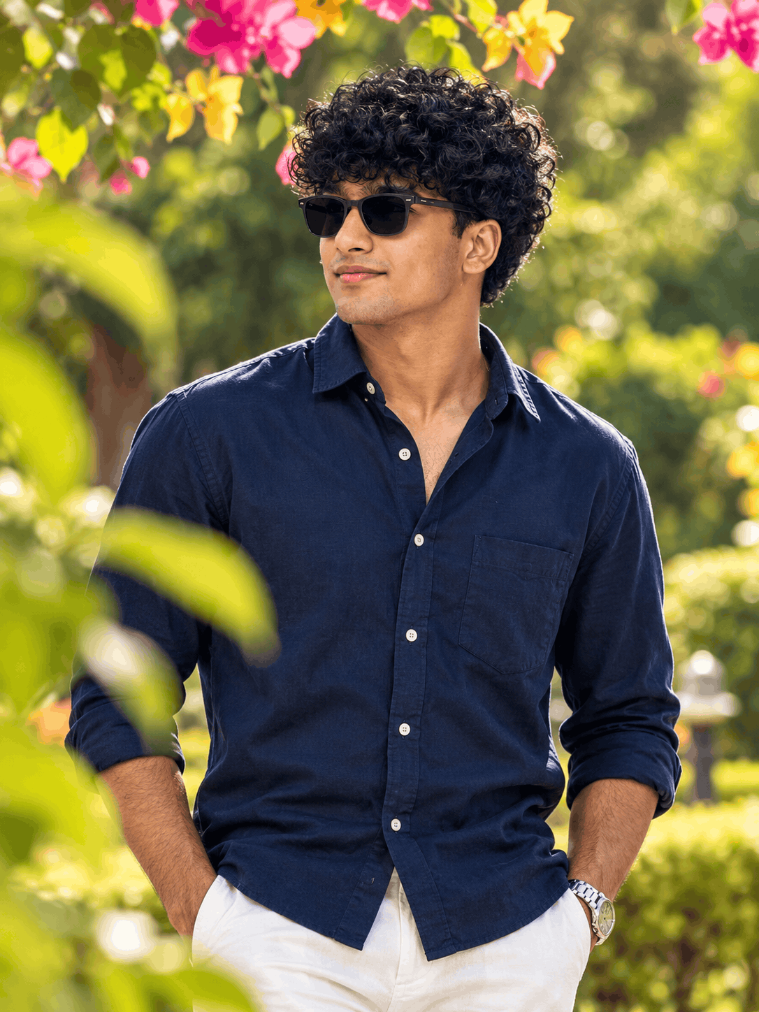 Stylish AI Outdoor Portrait of a Man in a Navy Blue Shirt and Sunglasses – Garden Bokeh Photography Prompt